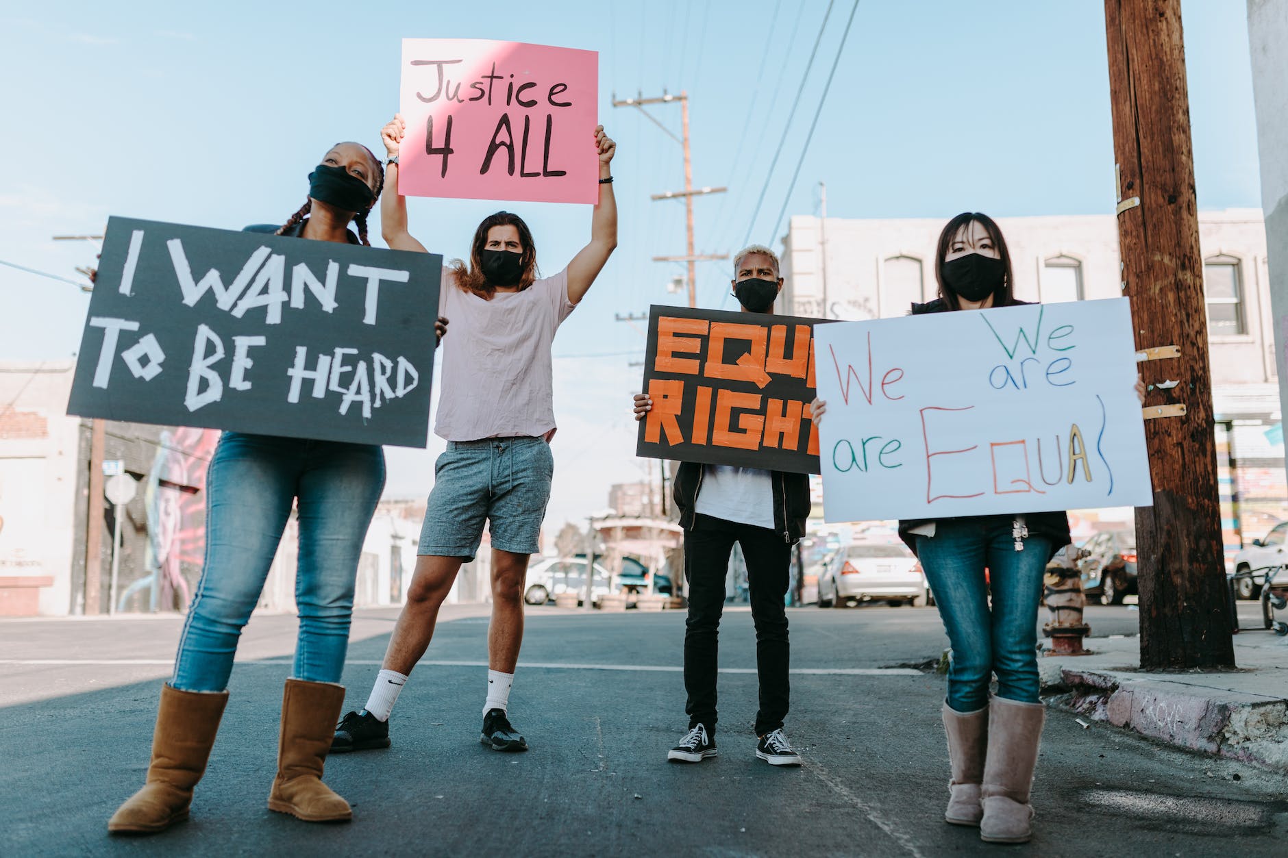 group of people standing on the street holding placards